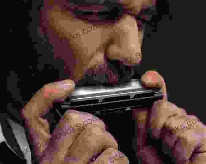 A Close Up Of A Harmonica Being Played By A Person's Hands. How To Play Harmonica: A Complete Guide For Absolute Beginners