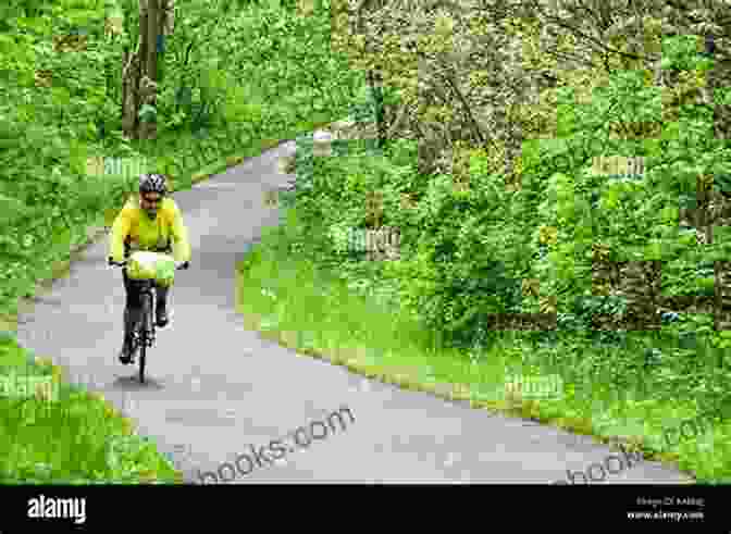 A Cyclist Riding Through A Lush, Green Countryside With Rolling Hills And Blue Skies. Exploring New Europe: A Bicycle Journey