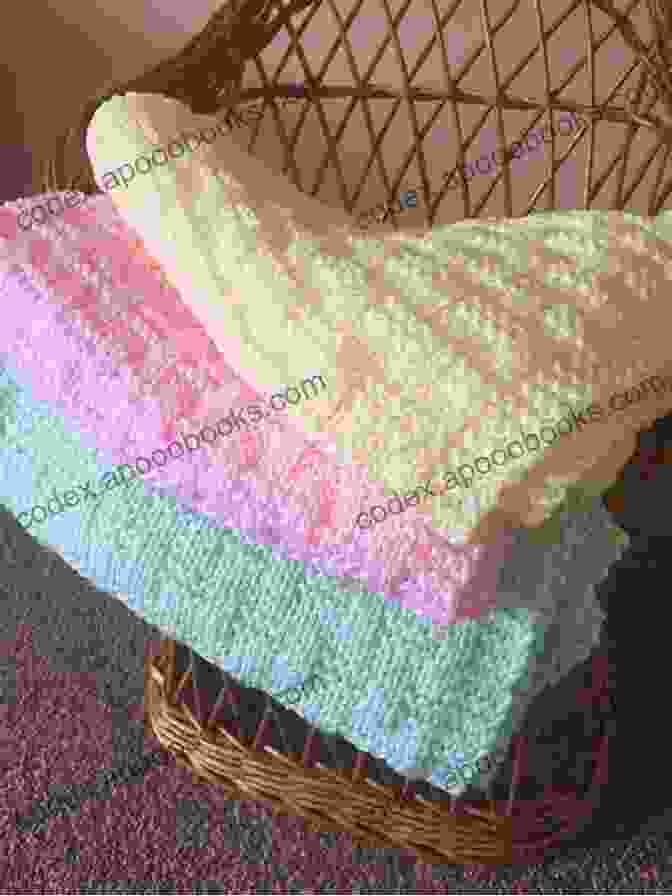 A Knitted Baby Blanket In Soft Pastel Colors Baby Punch Needle: Step By Step Instructions For 13 Projects